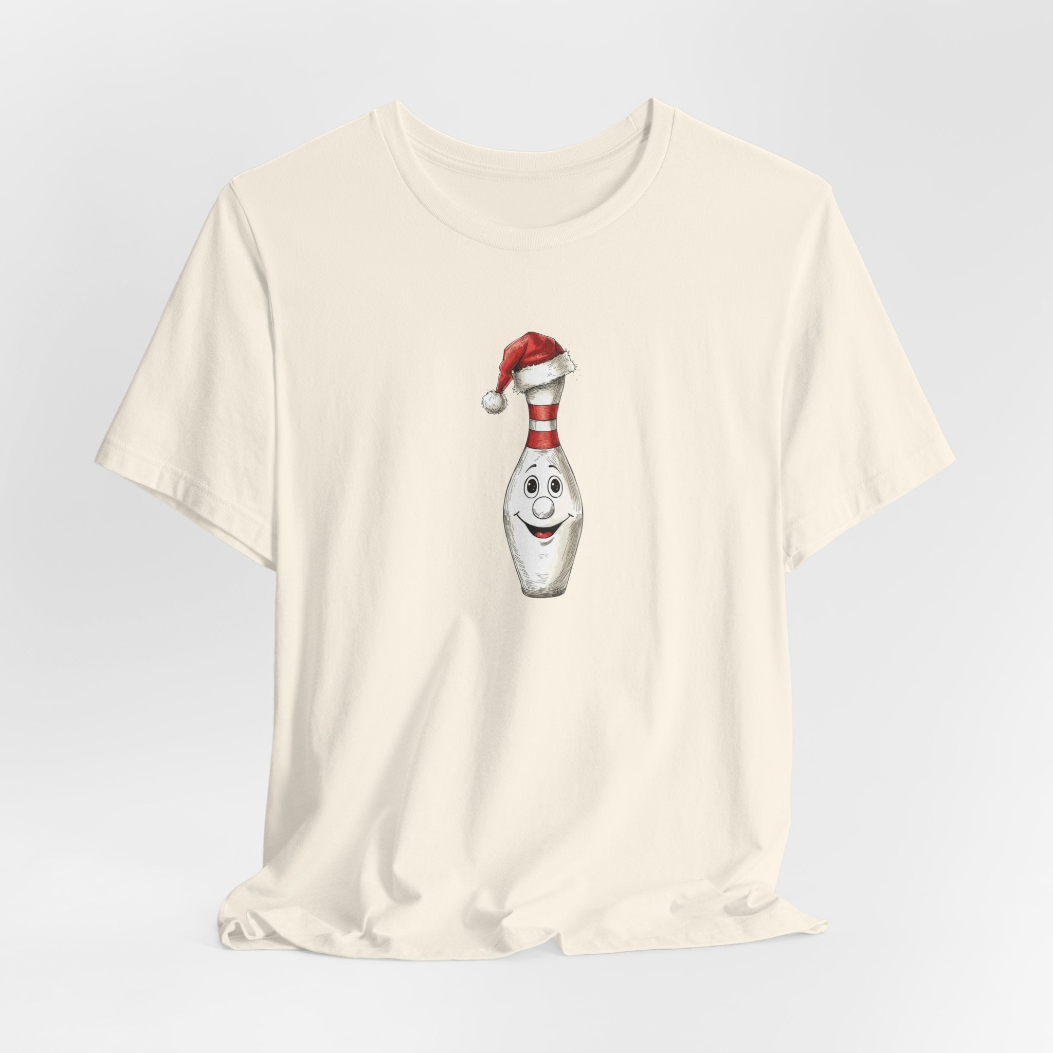 Beige t-shirt with a bowling pin wearing a Santa hat graphic on a light gray background