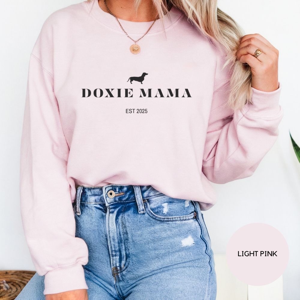 Light pink Doxie Mama crewneck sweatshirt modeled by woman, cute dog mom apparel