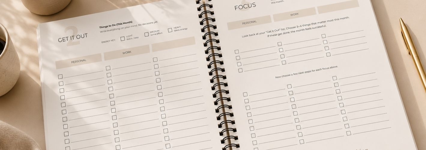 Wide lifestyle image of The Reset Planner open on a minimalist beige desk featuring the “Get It Out” and “Focus” planning pages with coffee, laptop, and gold pen accents.