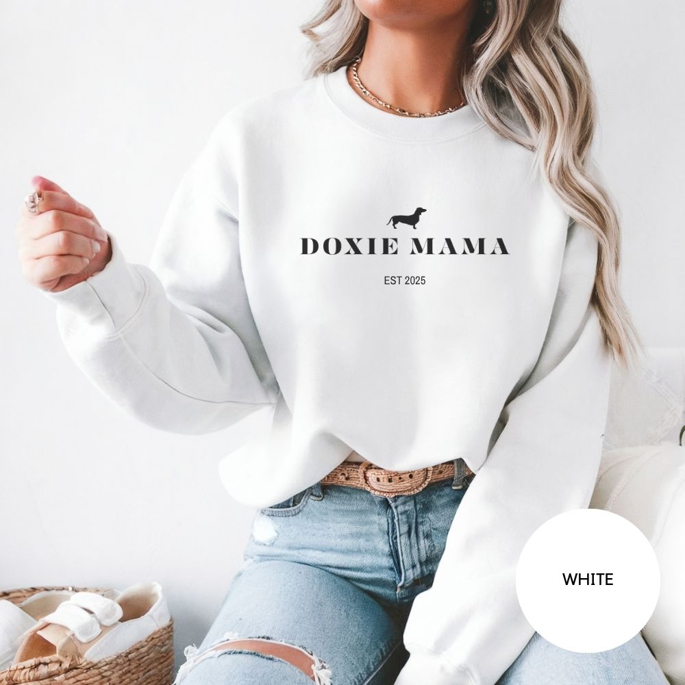 White Doxie Mama crewneck with dachshund silhouette, labeled color swatch, dog mom gift idea